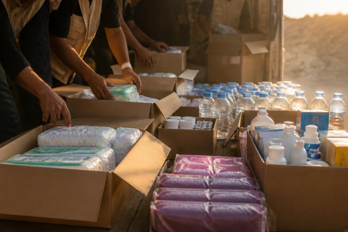 Humanitarian aid boxes with food, water, medical supplies, and hygiene products for Gaza